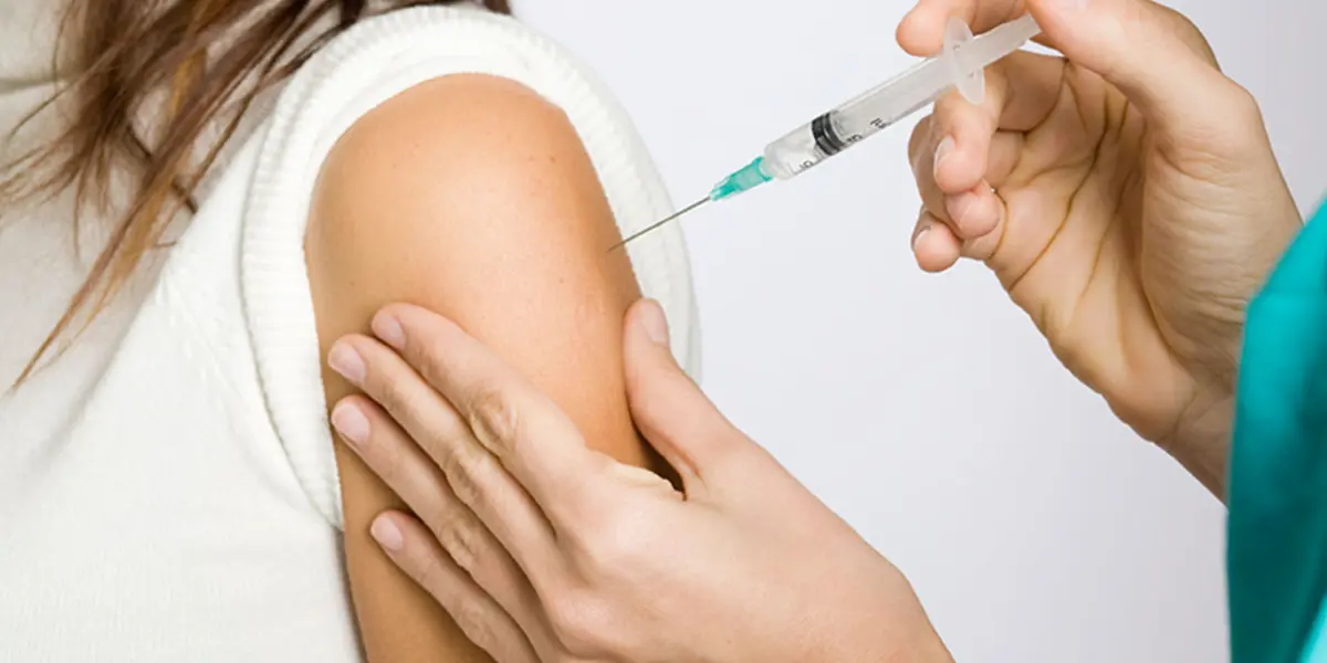 erson receiving a vaccine injection in the upper arm to prevent Shingles.