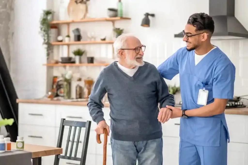 My Lotus support worker assisting an elderly man at home as part of Daily Living Support under NDIS services Gold Coast.