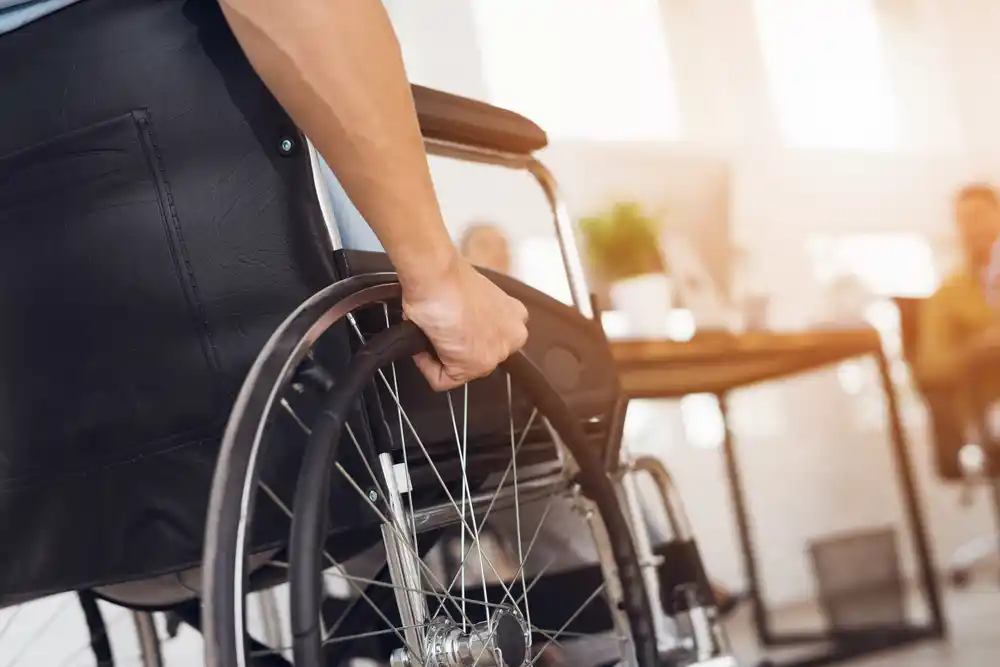 A close-up of a person in a wheelchair, illustrating the importance of responding to abuse in disability support.